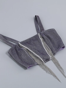 Detail of purple cropped top featuring shimmering denim texture and silver fringe chains