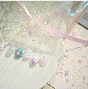 Macro view of ocean-themed 3D embossed nail stickers with pearlescent sea life designs