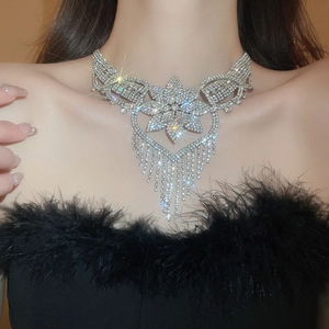 Macro shot of silver flower necklace with sparkling rhinestone fringe on a model