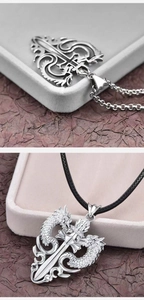 Detail of silver double dragon sword pendant with metal chain and black leather cord