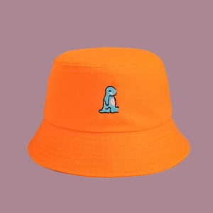 Detailed close-up of orange cotton bucket hat featuring blue dinosaur embroidery