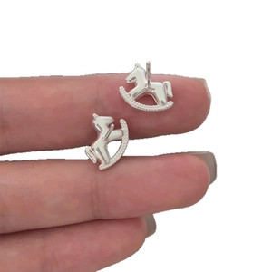 Minimalist silver rocking horse stud earrings featuring a polished sparkling finish