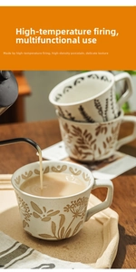 Detail of hand-painted ceramic coffee mug with vintage floral pattern and textured finish