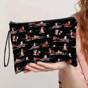 Portable makeup bag featuring festive dog sledding print with a sturdy black wrist strap