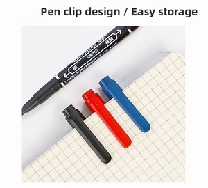 Close-up of double-headed waterproof marker clips on a grid notebook for storage display