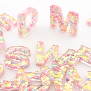 Resin initial keychain with colorful heart sequins and polished metal ring