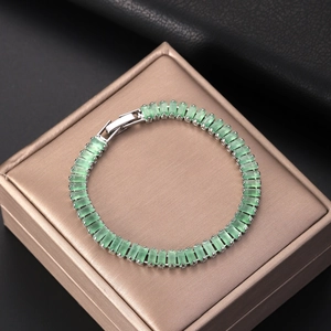 Elegant tennis bracelet featuring green rectangular zircons in a silver finish setting