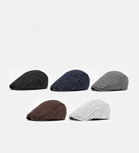 Detail of five plaid flat caps in various colors showing fabric texture and windowpane pattern