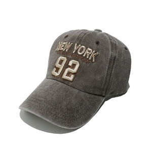 Close-up of grey vintage washed baseball cap with 3D New York athletic embroidery detail