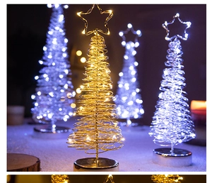 Close-up of golden LED iron wire Christmas tree with star topper and warm glowing lights