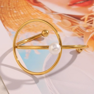 Macro view of 18K gold plated stainless steel knot bracelet with a white pearl accent