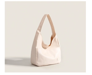 Minimalist beige tote bag in high-quality synthetic leather with detailed stitching