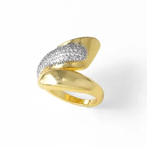 Polished wavy 18k gold plated copper ring with pave set cubic zirconia accents