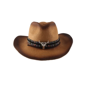 Western style wide brim straw cowboy hat with ethnic band and silver bull skull ornament
