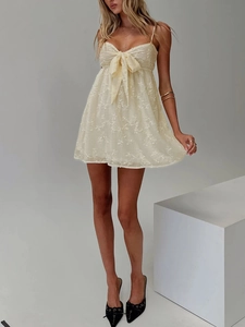 Elegant pale yellow lace mini dress with spaghetti straps and bow detail on front