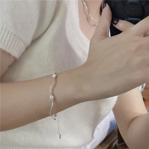 S925 sterling silver curved tube bracelet with freshwater pearls on wrist model