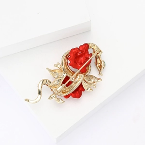 Detailed back view of a luxury gold snake and rose brooch with pin attachment mechanism
