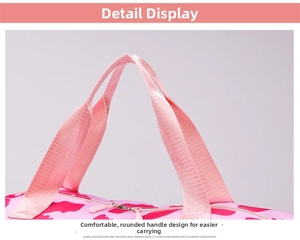Detail view of pink travel bag showing comfortable webbing handles and metal zippers