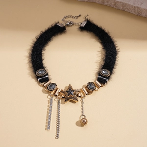 Detail of plush choker with gold stars, black rhinestones and metallic fringe tassels