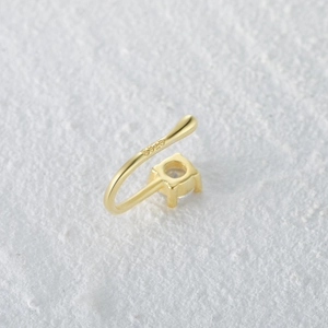 Detailed macro view of S925 sterling silver stamp on a gold-plated teardrop nose cuff