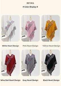 Detailed multi-color display of V-neck knitted heart pattern ponchos with long tassels