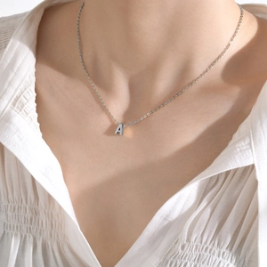 Silver letter A pendant necklace for women in polished stainless steel on a model