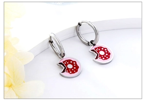 Detail of pink donut pendant earring with white sprinkles on a silver hoop