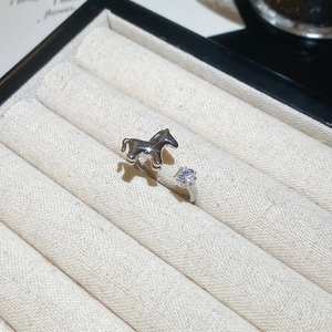 Close-up of adjustable silver star ring with polished pony detail and sparkling zircon