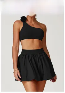 Detail of the 3D rose flower ornament on the shoulder of the black athletic tennis dress