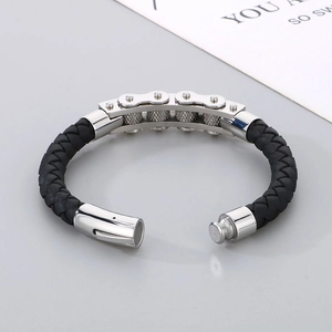 Detail of men's braided leather bracelet featuring a silver stainless steel bike chain inlay