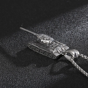 Macro shot of silver stainless steel tank pendant showing intricate tracks and turret detail