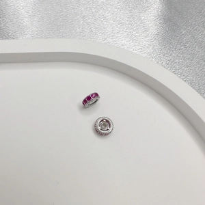 Macro detail of S925 silver spacer beads with inlaid pink zircons for DIY jewelry