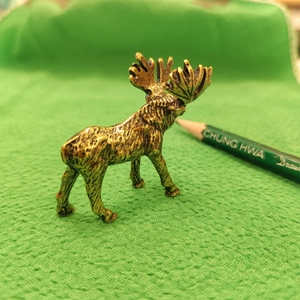 Vintage bronze elk figurine home decor sculpture on textured green background