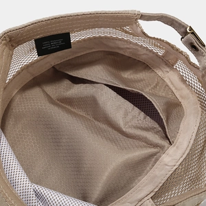 Detail showing the breathable mesh inner lining and sweatband of the beige military cap