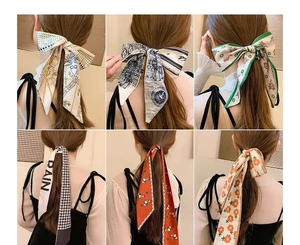 Detail showing six styles of ribbon hair ties including polka dots and floral patterns