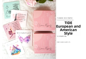 Macro view of motivational affirmation cards with floral designs and pink gift packaging