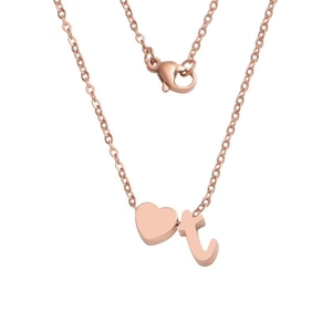 Detail showing rose gold heart pendant and lowercase letter t on a delicate chain