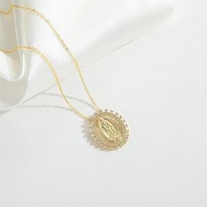 Gold plated Guadalupe oval pendant necklace with sparkling cubic zirconia on white silk