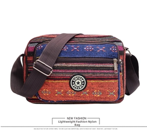 Detail of colorful striped Oxford fabric bag featuring an adjustable shoulder strap