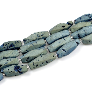 Macro detail of blue geode agate octagon beads with metallic luster and natural cavities