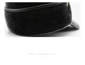 Detail of warm black faux fur texture and metal buckle on winter baseball cap for men