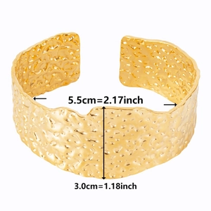 Detail of wide gold cuff bracelet with hammered texture and 3.0cm width dimensions