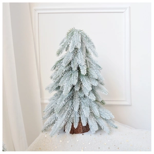 Close-up of a 45cm mini flocked Christmas tree with realistic snow and natural cedar wood base