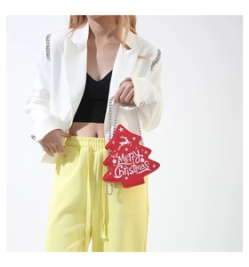 Detail of red Christmas tree bag with silver ball chain and Merry Christmas print