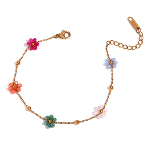 Golden flower bracelet with colorful beaded petals and lobster clasp on white background