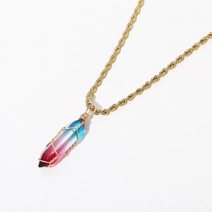 Detail of bohemian gold twist chain and gradient resin hexagonal prism pendant necklace