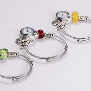 Adjustable stainless steel beaded watch bracelet with colorful heart charms on white background