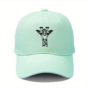 Detailed view of the precise black giraffe embroidery on a mint green baseball cap