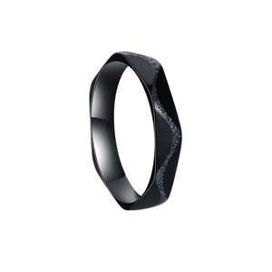 Macro detail of a 4mm black geometric ring with polished finish and frosted glitter texture