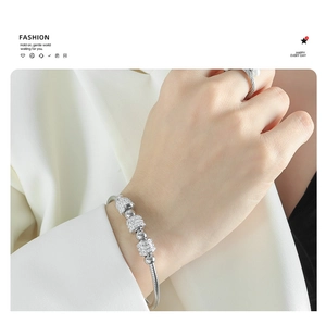 Close-up of luxury silver snake chain bracelet with sparkling rhinestone-paved charms
